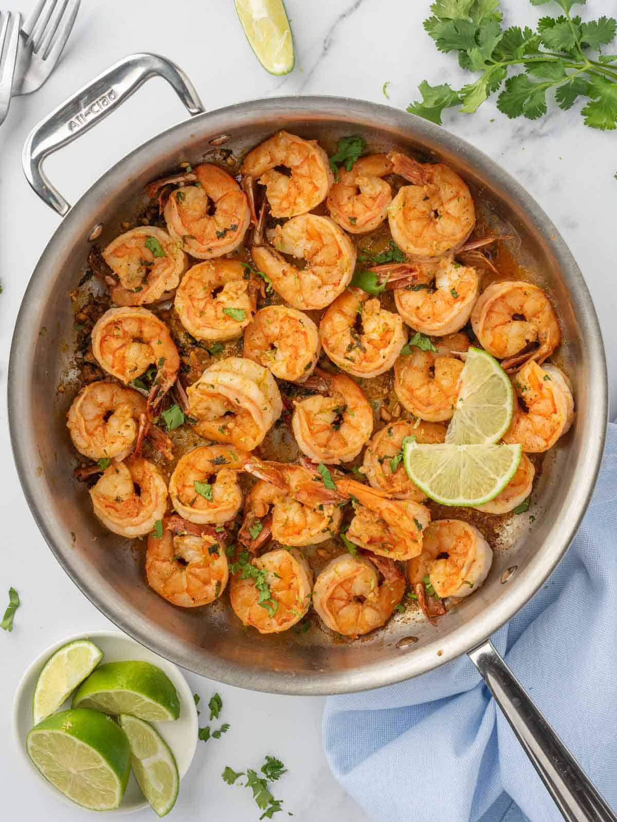 Shrimp with cilantro and lime in a skillet.