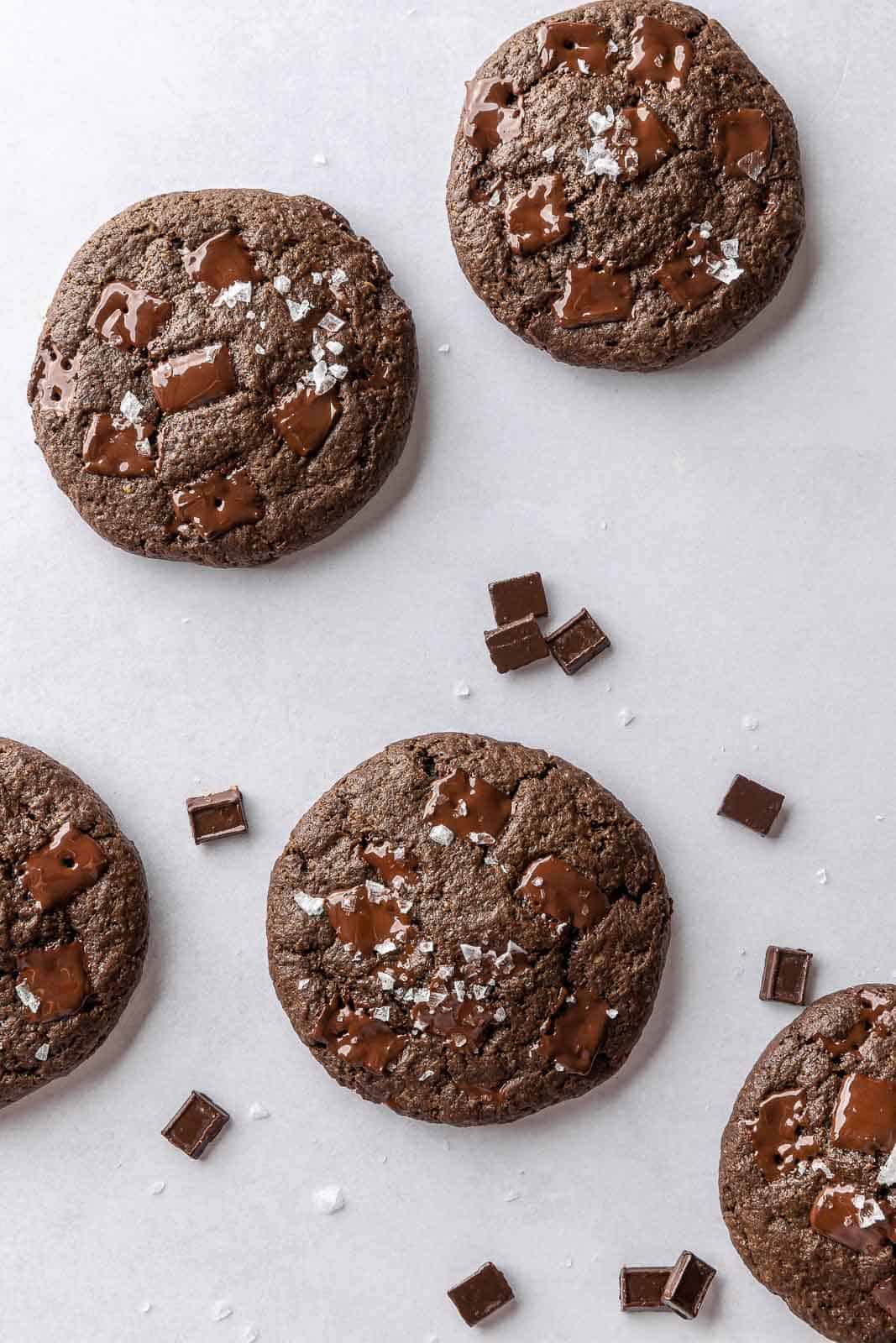 chocolate vegan cookies on a white surface.