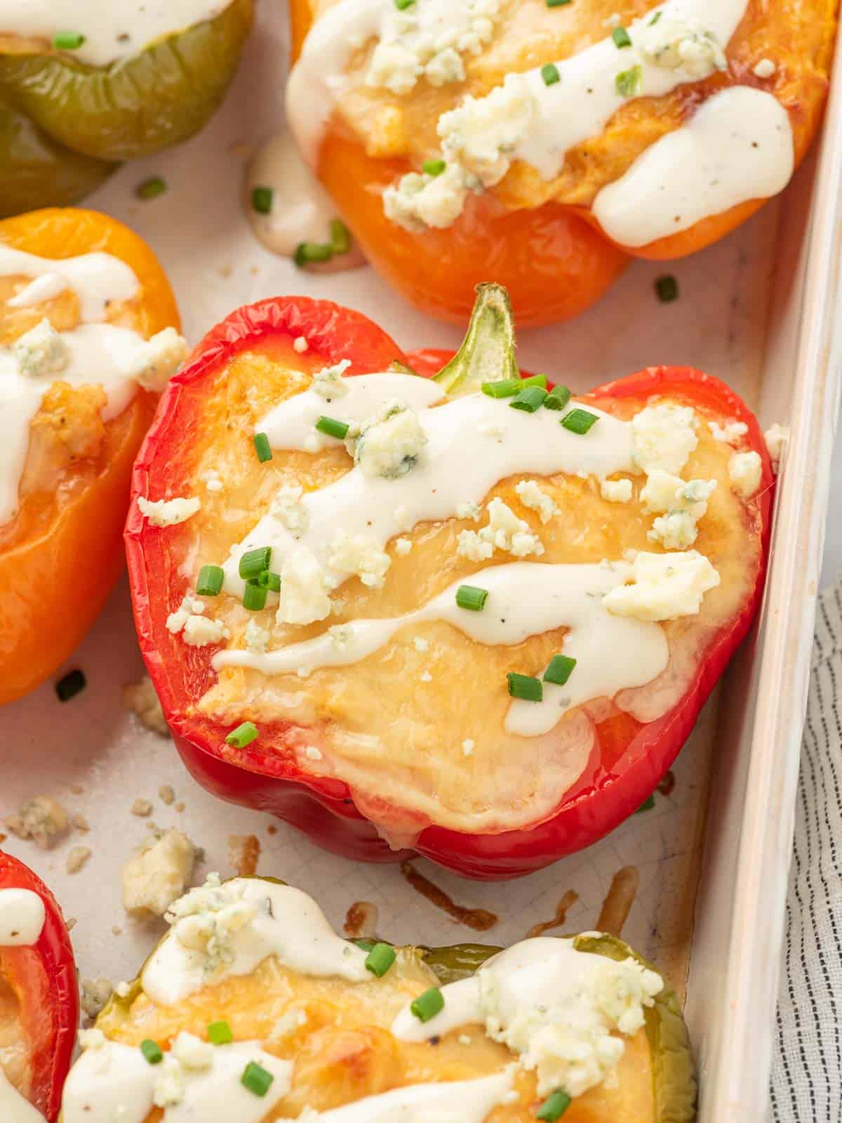 Closeup of buffalo chicken stuffed peppers in a dish.