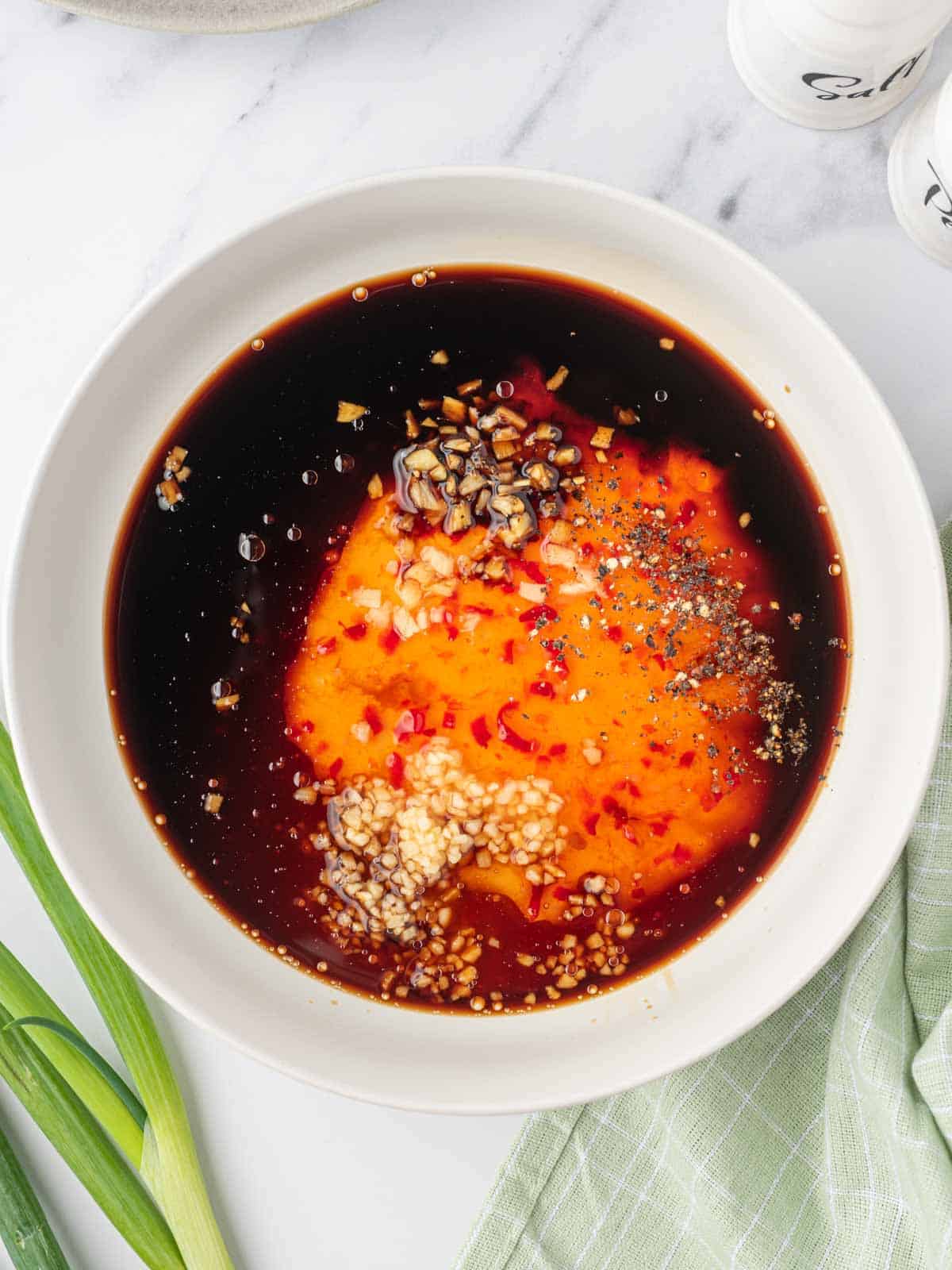 Process of making honey garlic sauce for chicken in a bowl.