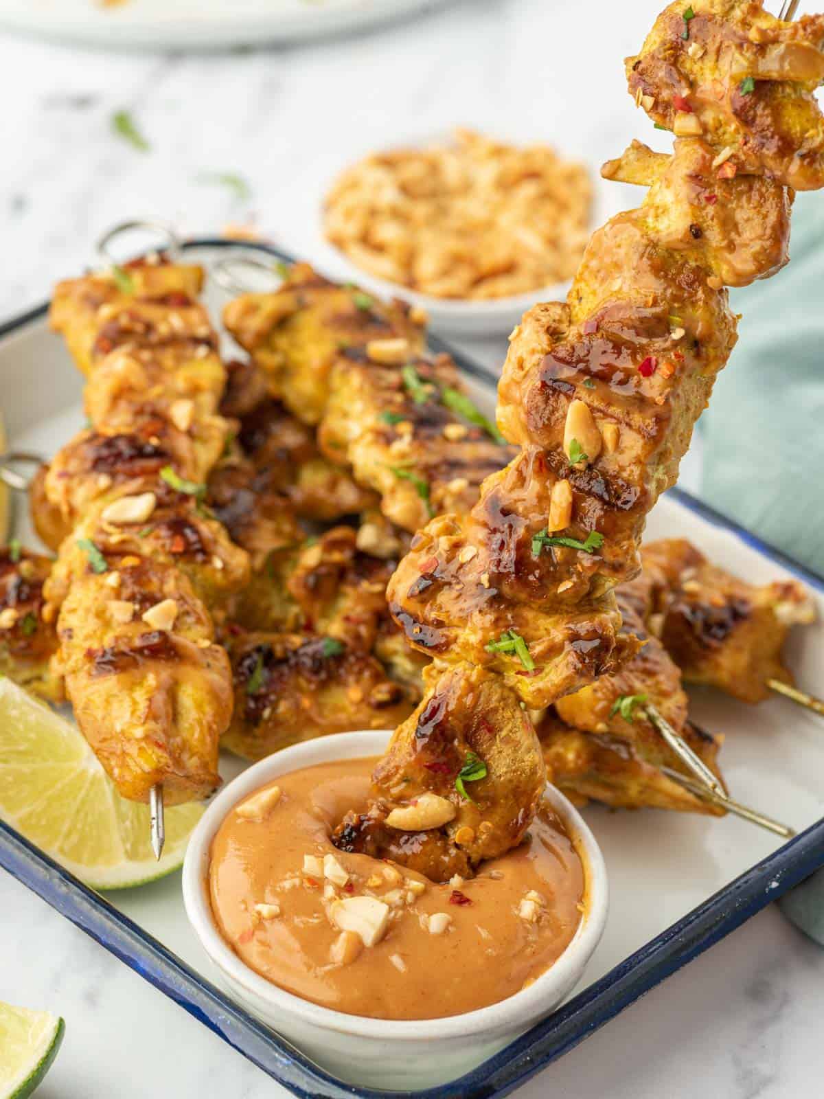 Dip chicken in peanut sauce for a delicious meal.