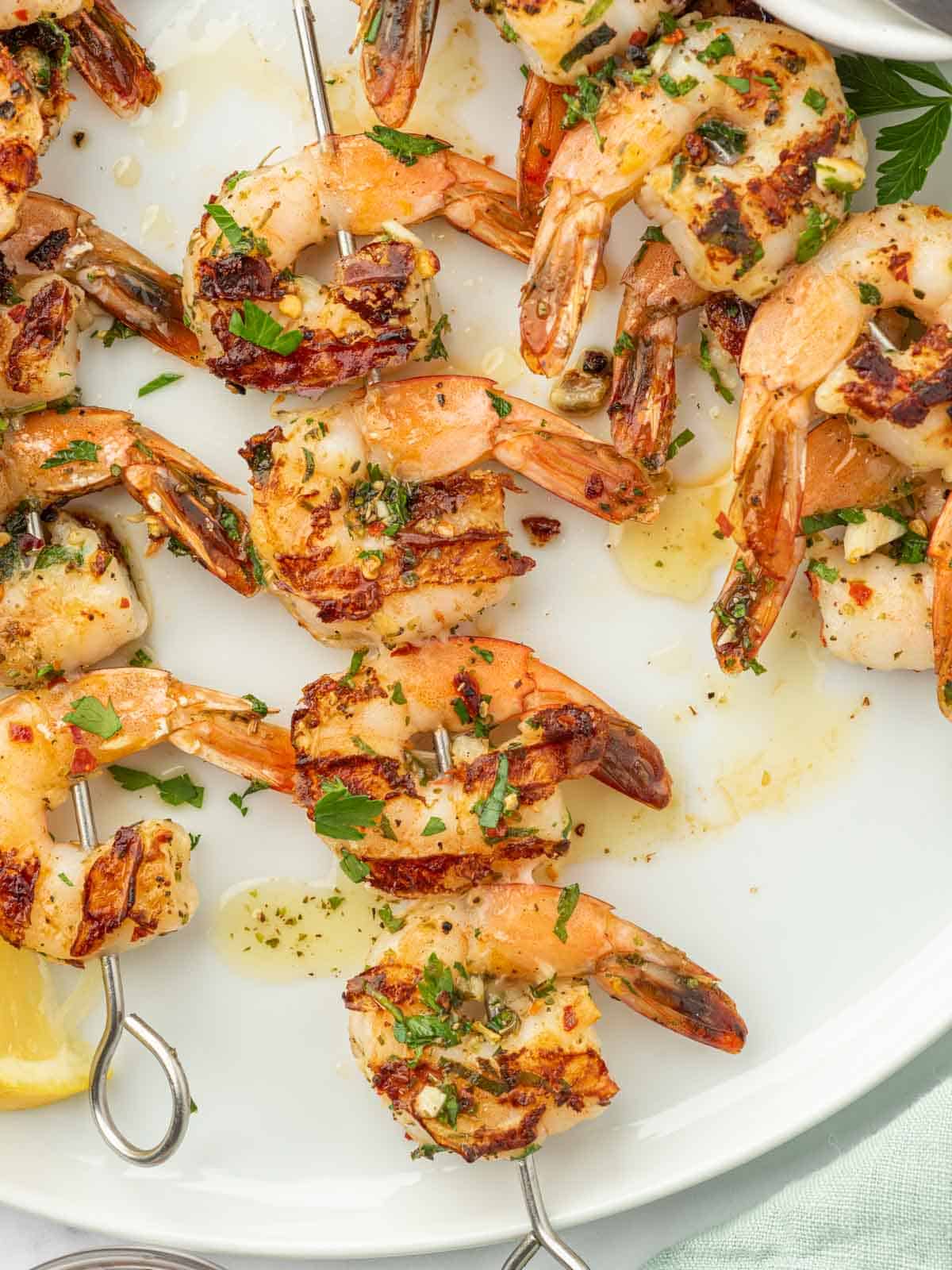 Garlicky shrimp skewers on a plate.