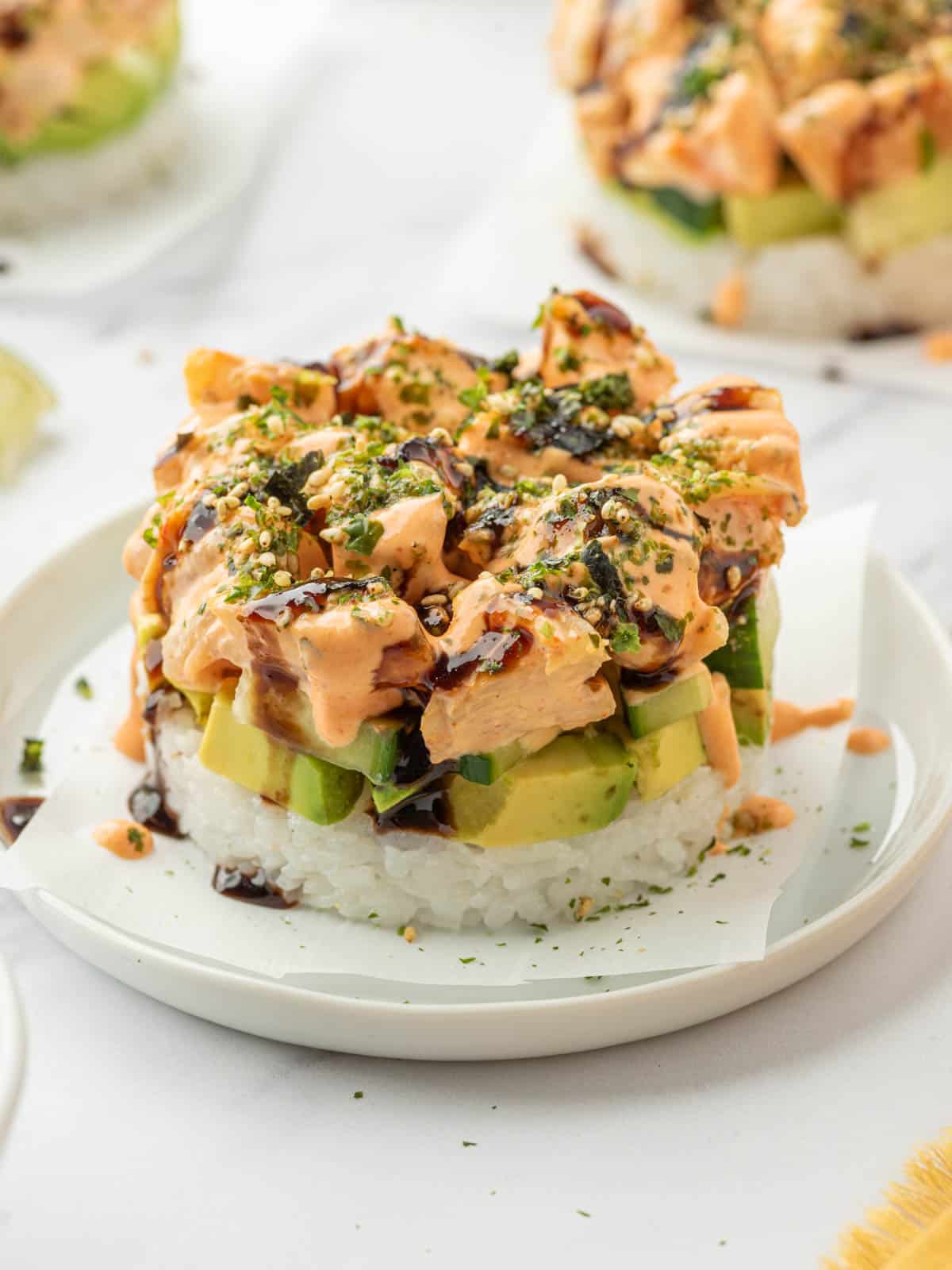 Closeup shot of a homemade shrimp sushi stack on a plate.