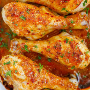 Golden-brown chicken drumsticks coated in a glossy honey mustard sauce with fresh parsley.