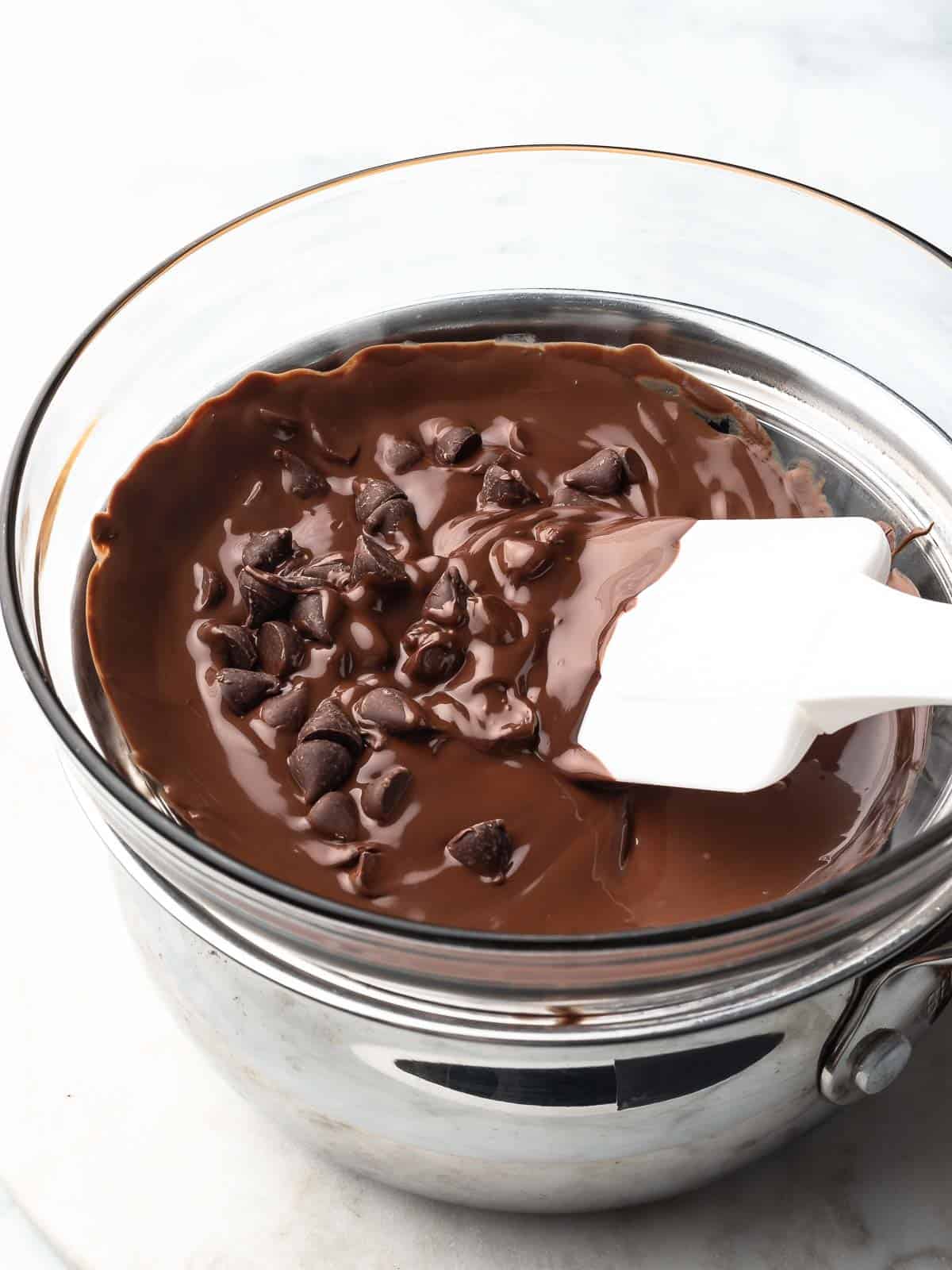 Chocolate chip pieces in a double boiler melting.