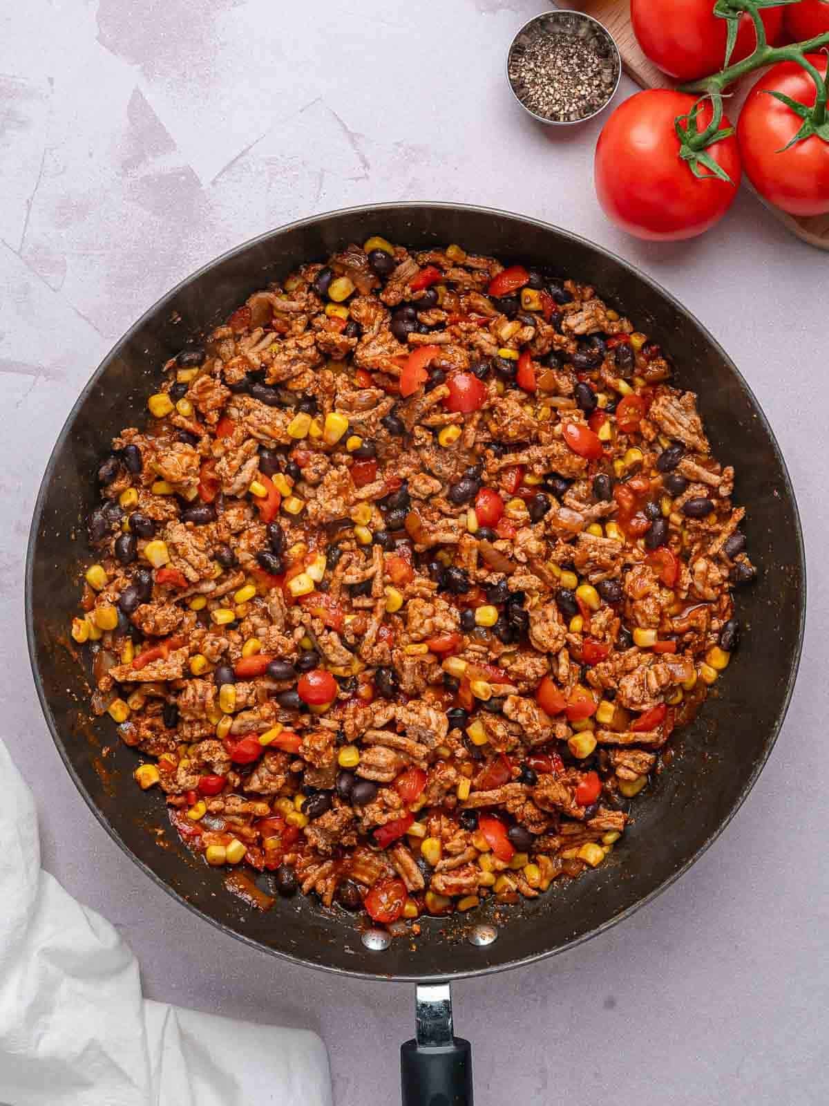 Cooked ground turkey filling with black beans, corn, tomatoes, and seasonings.