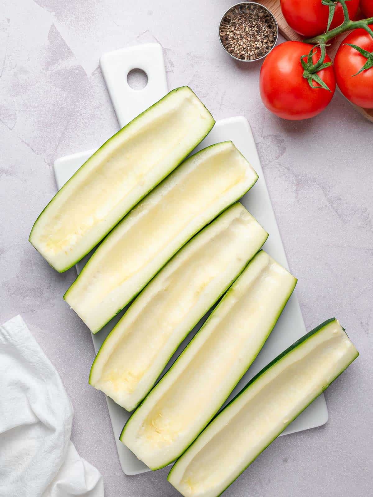 Zucchini halves with the centers scooped out for the filling.