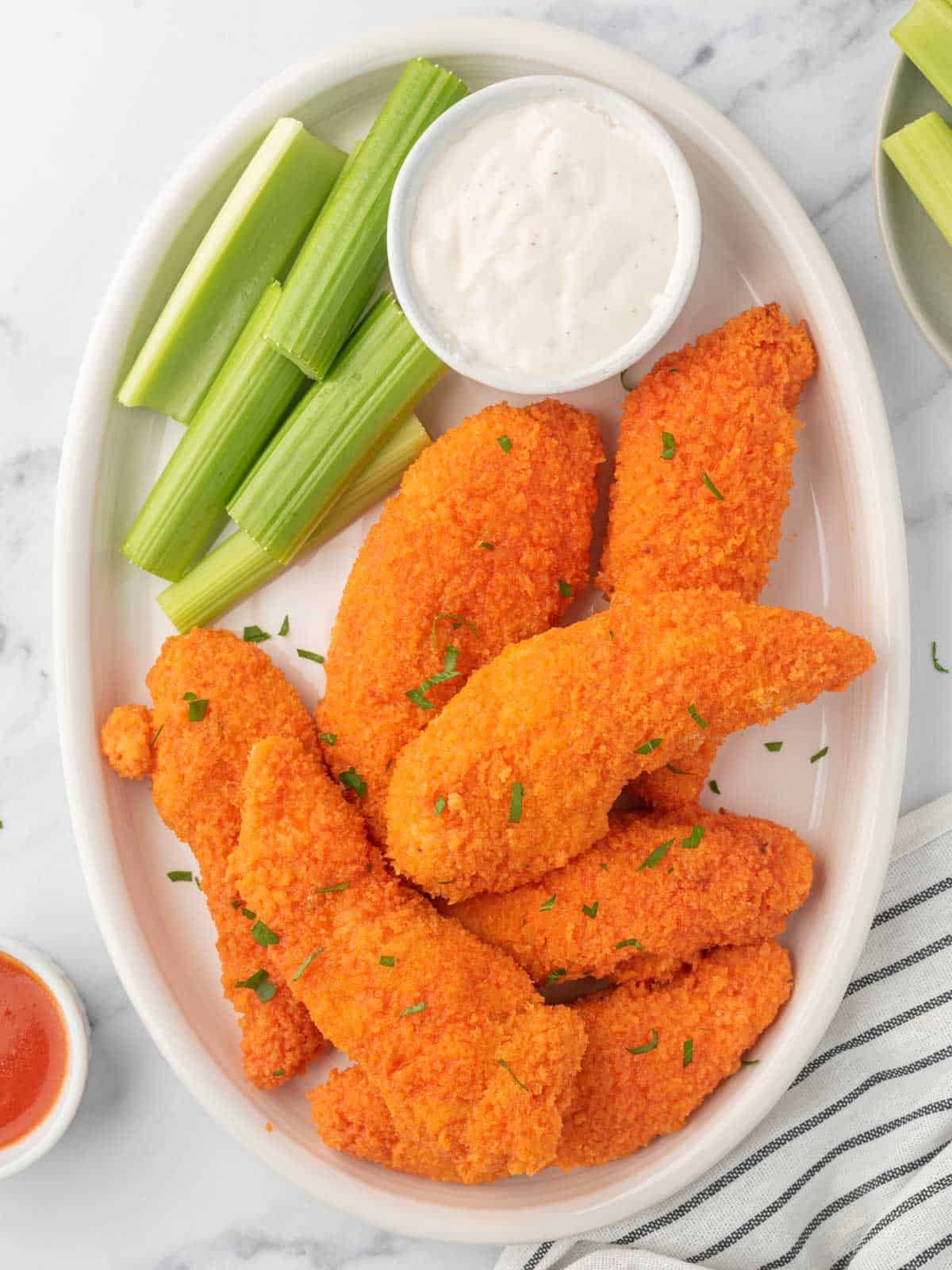 A plate of crispy buffalo chicken strips.