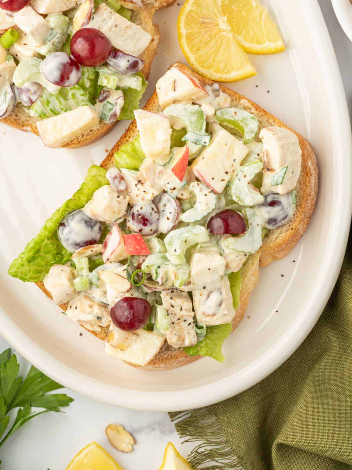 Healthy chicken salad on toast on a serving plate.