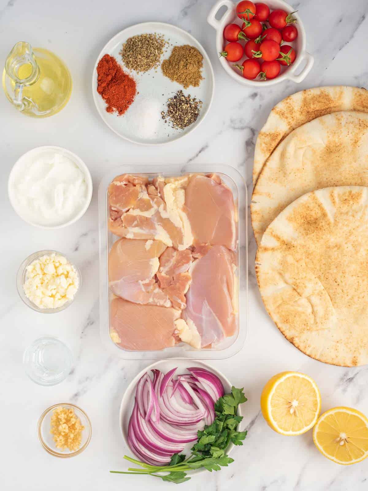 Ingredients needed for homemade greek chicken gyros.