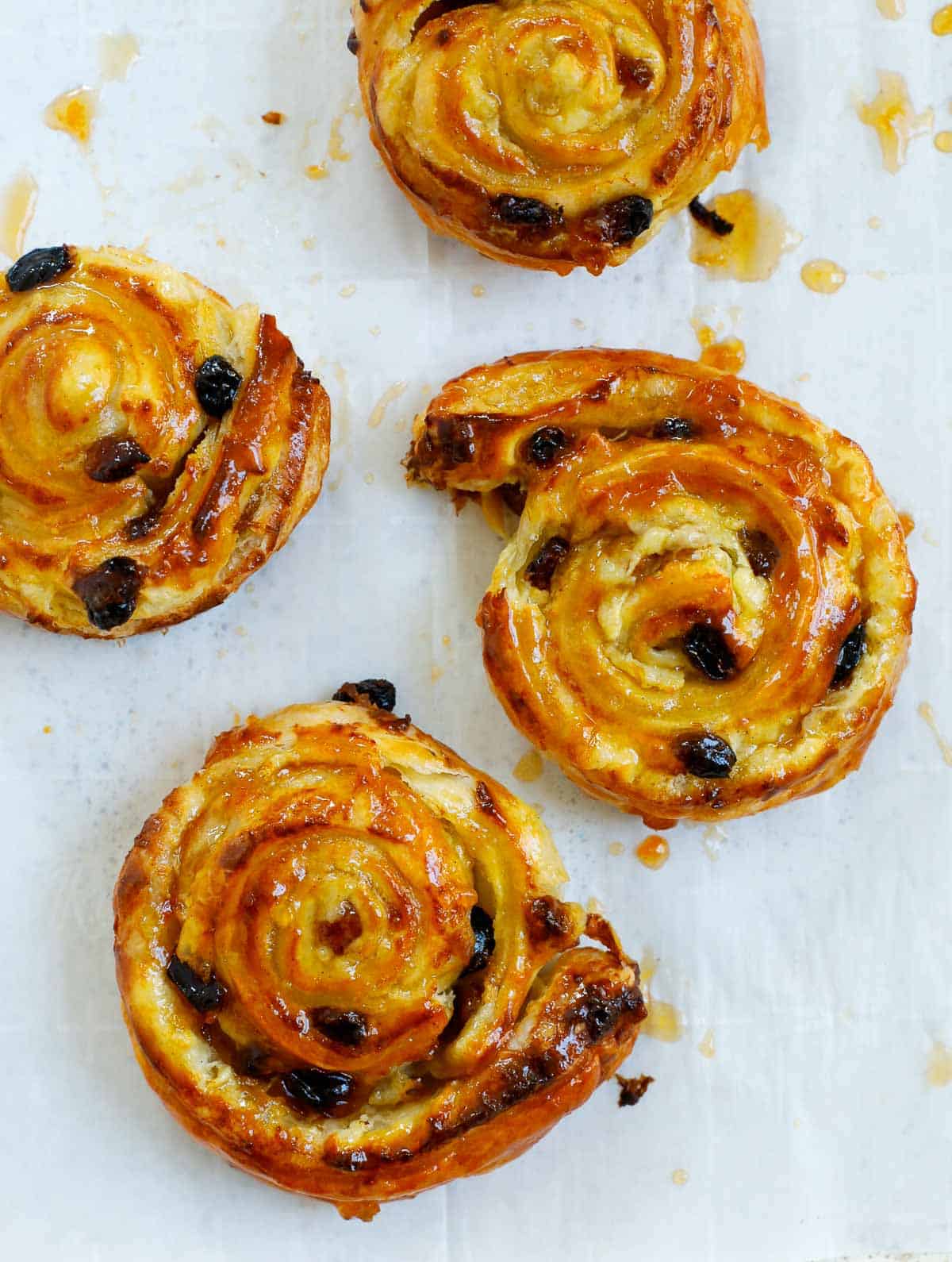 baked pain aux raisins on a sheet pan.