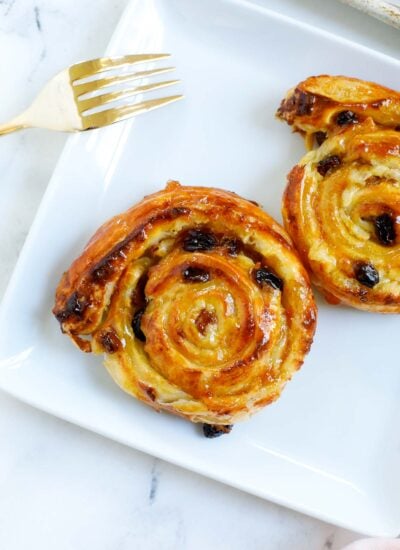 baked pain aux raisins served on a plate.