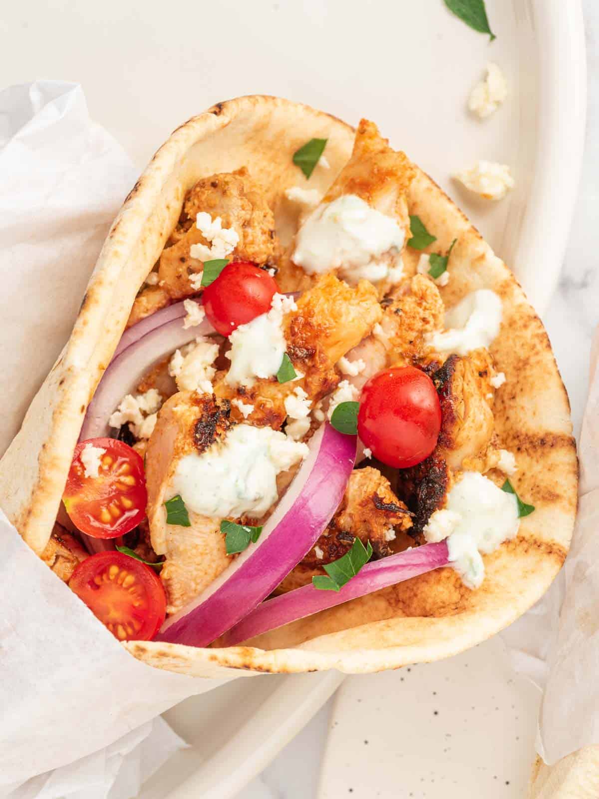 Closeup of Greek Chicken Gyros with Tzatziki Sauce.