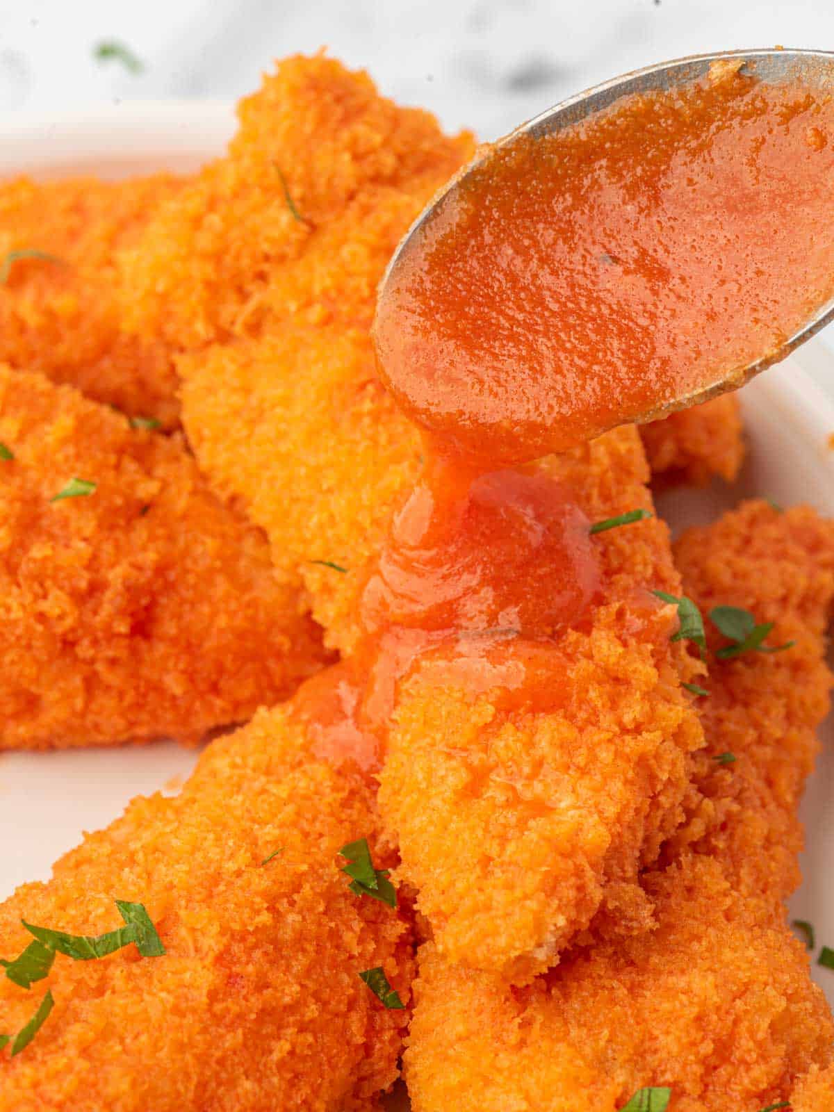 Drizzle buffalo sauce over crispy chicken tenders.