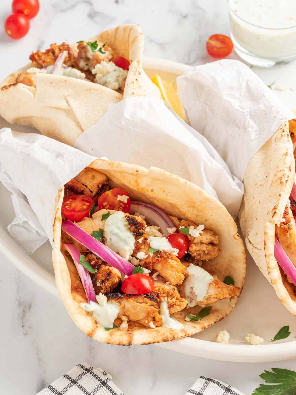 Authentic chicken gyros on a platter.