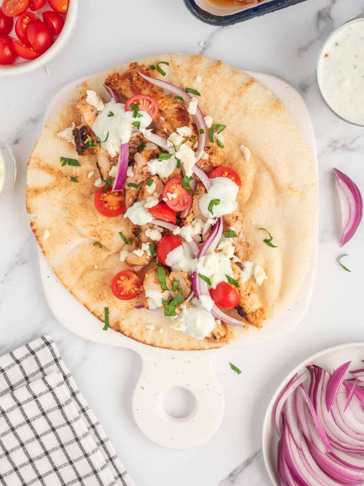 Assembled gyro chicken recipe on a platter.