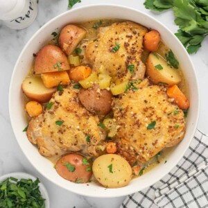 A bowl of honey dijon chicken thighs.