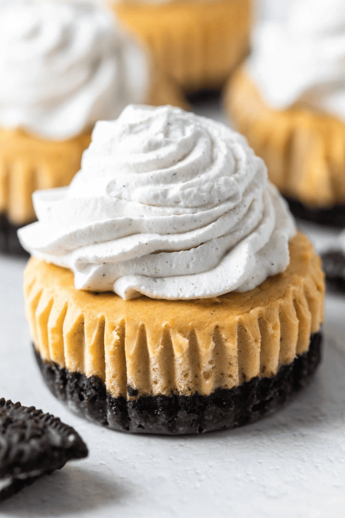 Pumpkin cheesecake topped with piped pumpkin spice whipped cream.