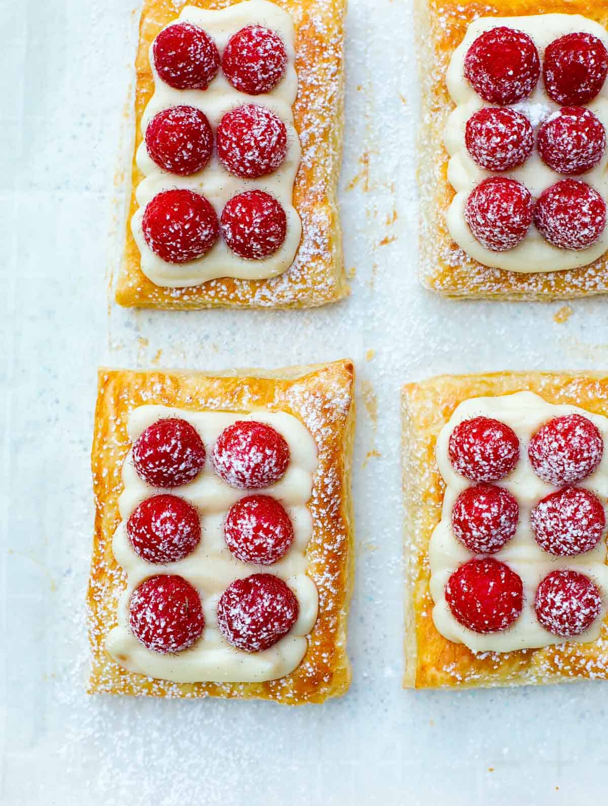 raspberry tart on a sheet pan, dusted with powdered sugar