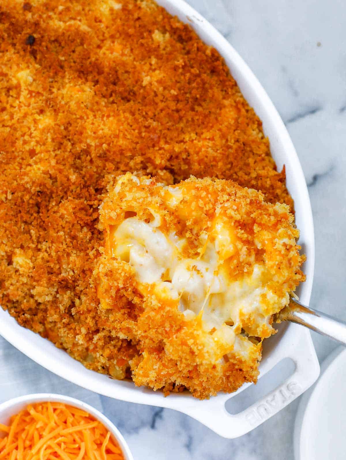 spoon scooping out the mac and cheese from the baking dish