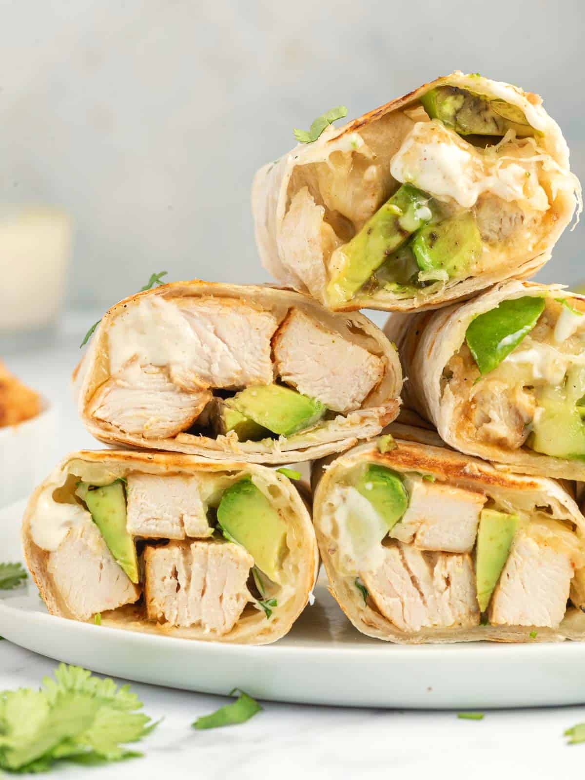 A stack of chicken avocado wraps ready to serve.