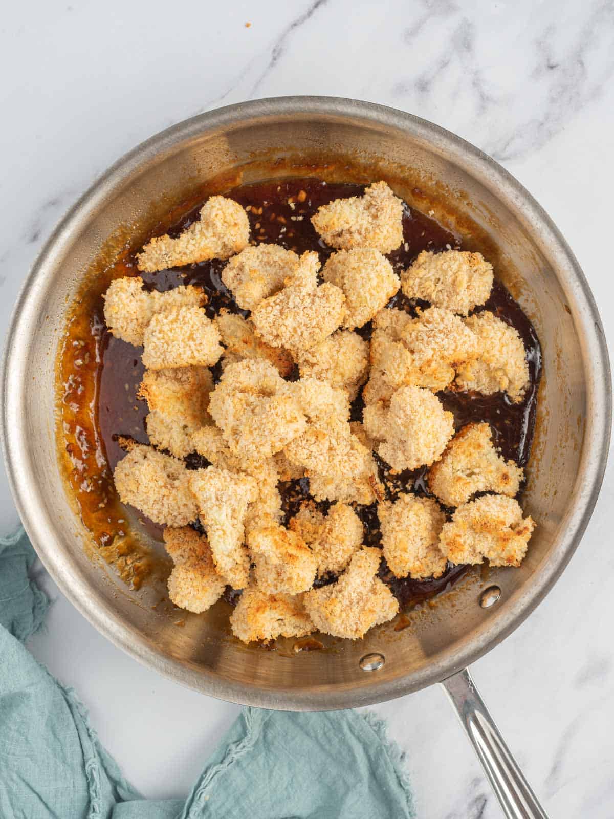 Baked cauliflower bites are tossed with asian sesame sauce.