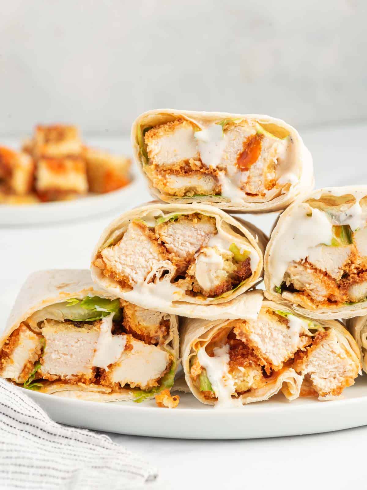 A platter of spicy chicken wrap sandwiches.
