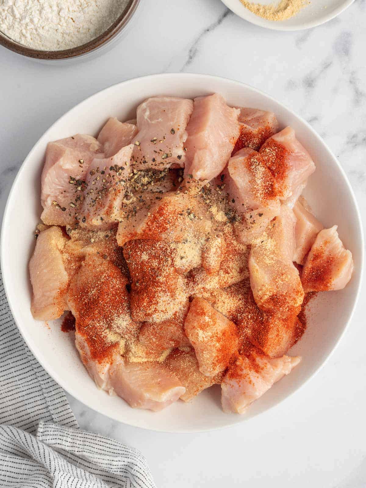 Toss chicken with seasoning.