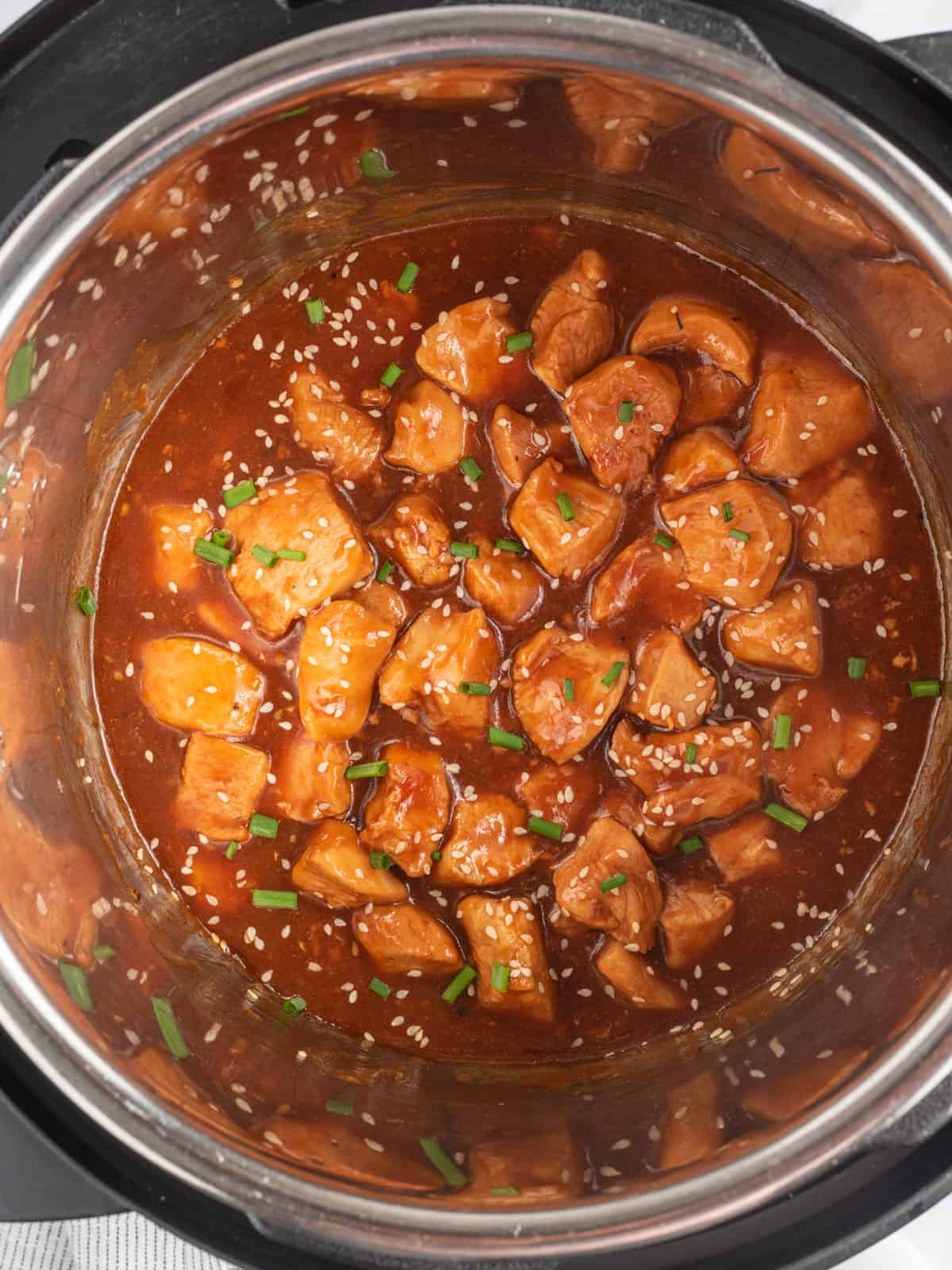Instant Pot insert filled with chucks of chicken in sesame sauce.
