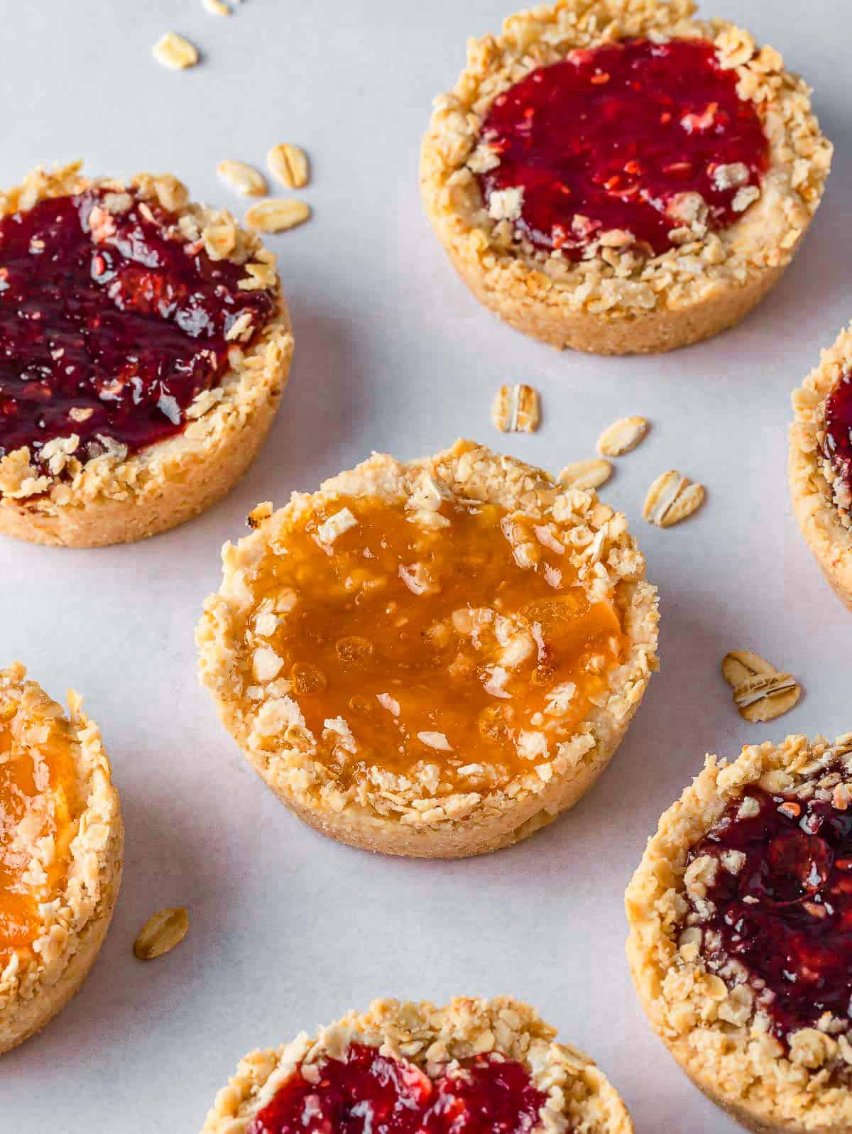 Oatmeal jam biscuits on a tray.