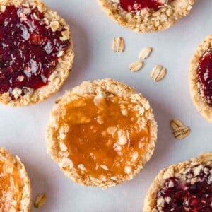 Several oatmeal jam cookies on a tray.