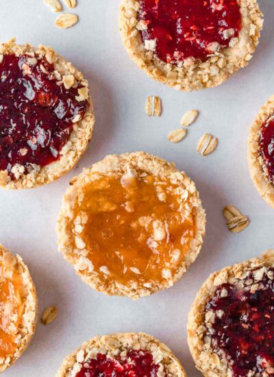 Several oatmeal jam cookies on a tray.