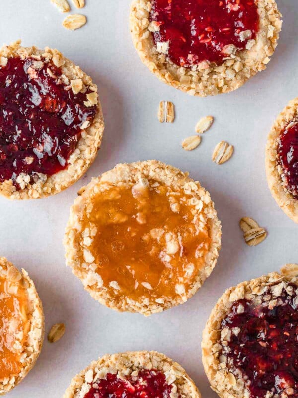 Several oatmeal jam cookies on a tray.