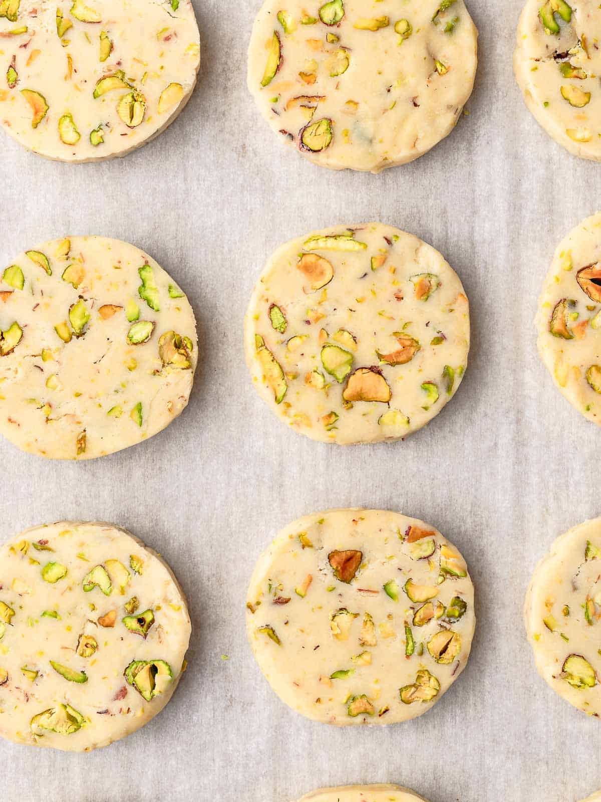 Sliced of shortbread cookies on a tray, ready to bake.