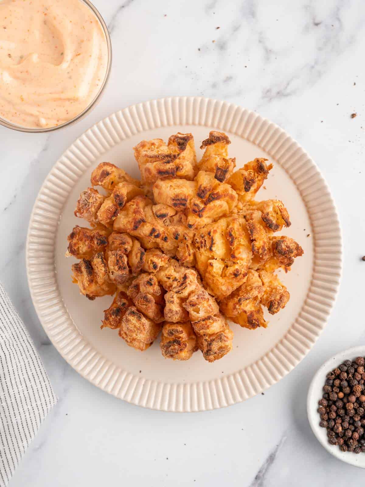 Blooming onion air fryer on a plate.