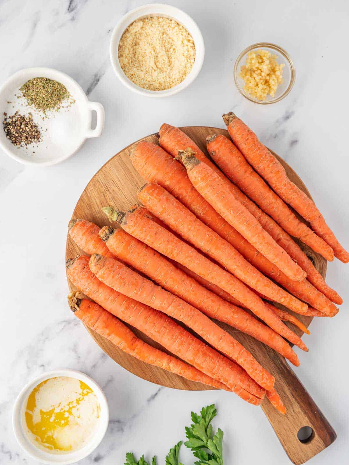 Roasted carrots with Parmesan and parsley spread across a baking sheet.