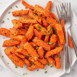 Roasted carrots coated with Parmesan and herbs on a white plate.