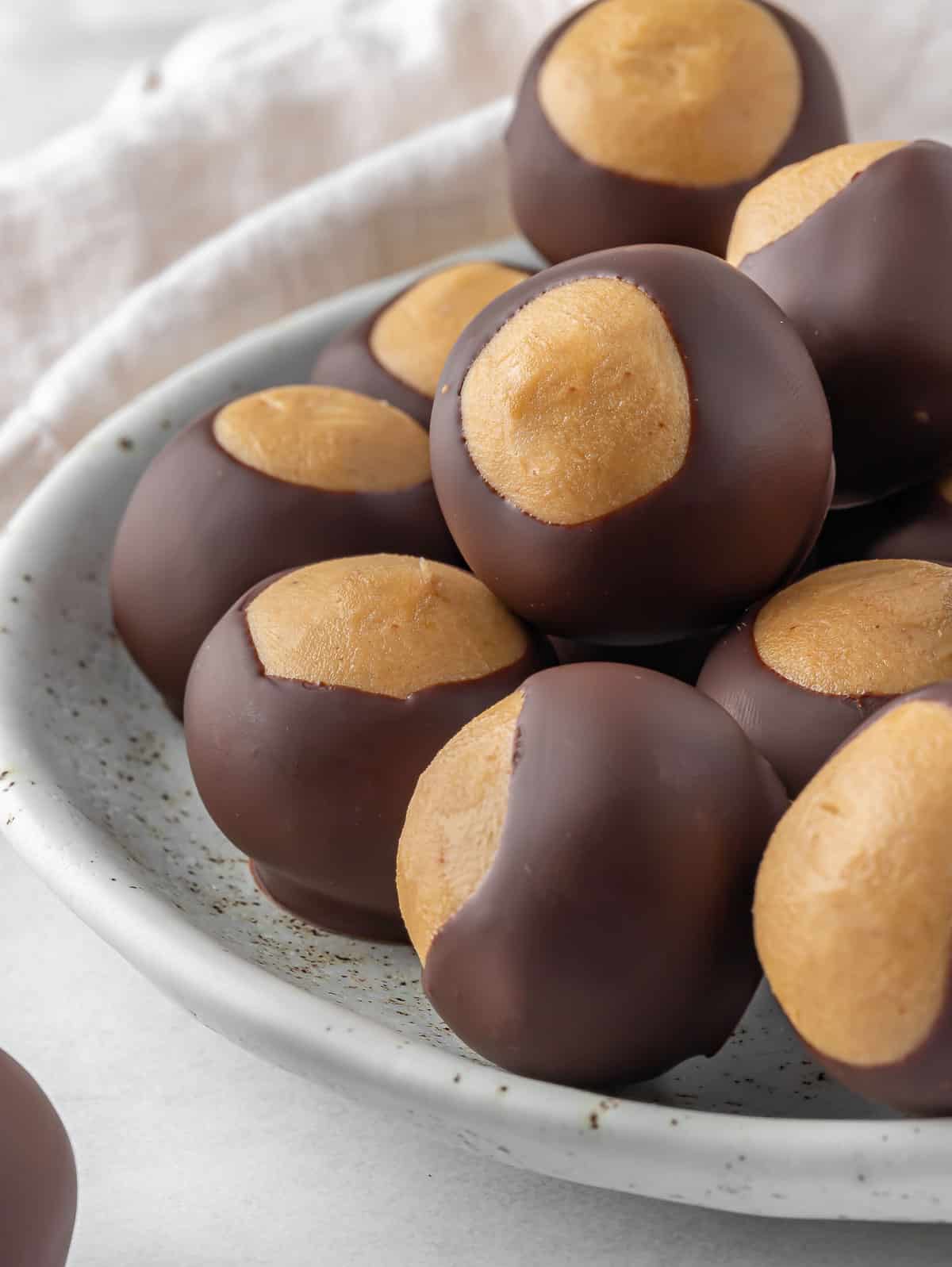 A pile of buckeye candy balls on a plate.