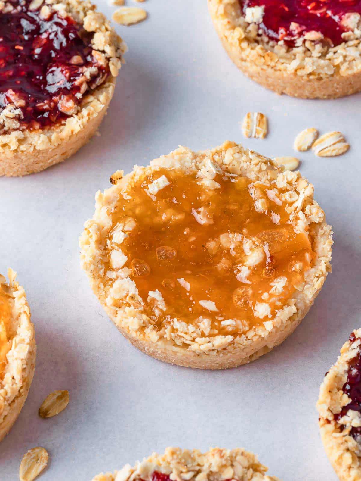 Cookies with jam filling on a tray.