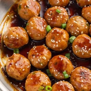 A pan of meatballs with teriyaki sauce.