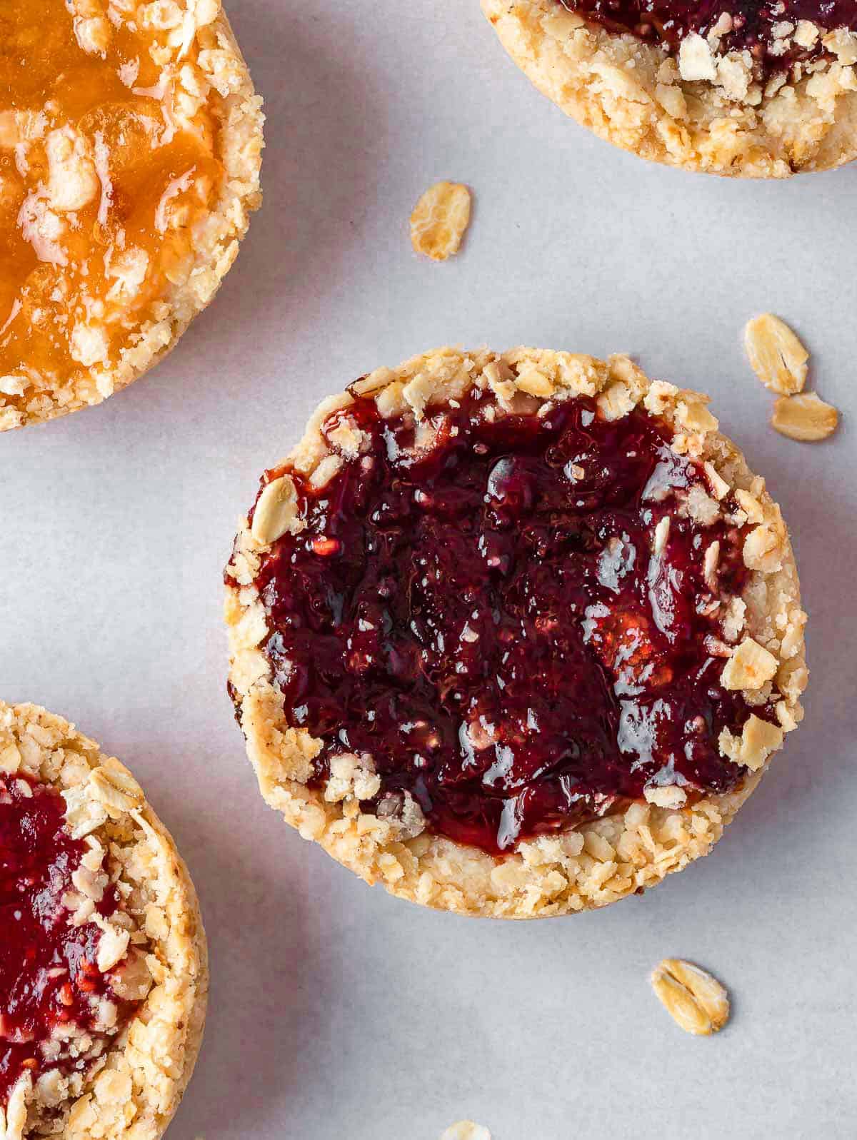 closeup of jam filled cookie on a tray.