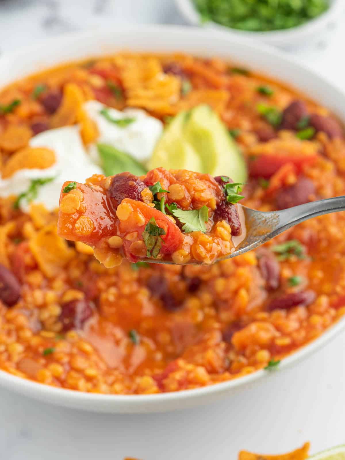 Closeup of a spoonful of chili with lentils.