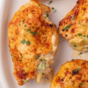 Close up of broccoli stuffed chicken on a platter.