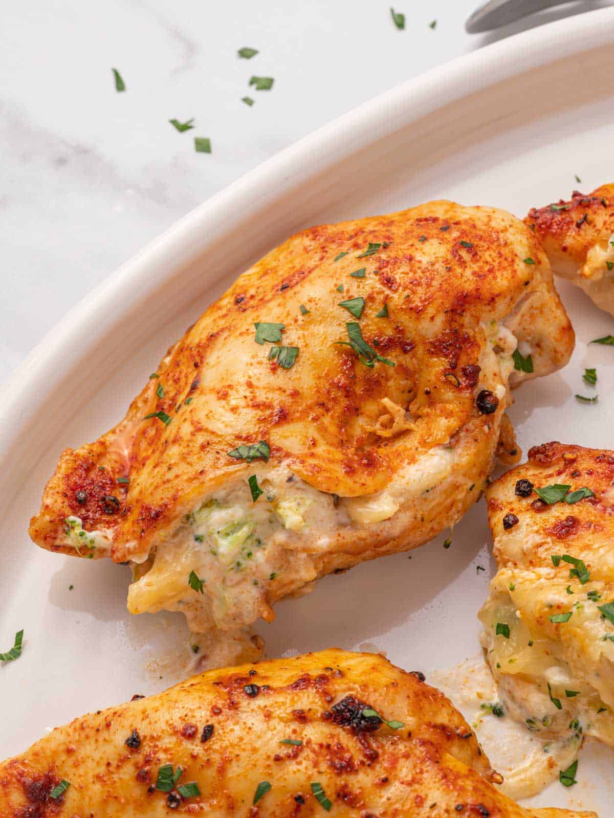 An air fryer chicken breast on a platter.