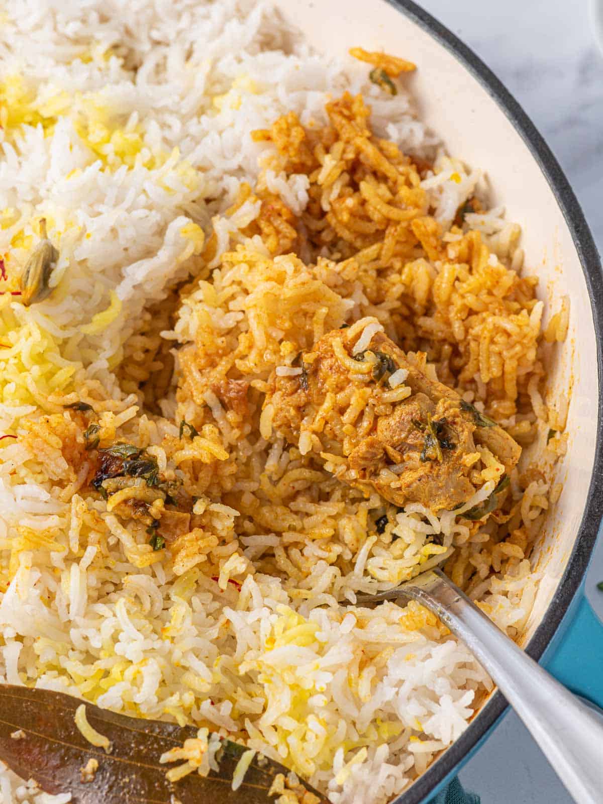 A forkful of chicken biryani.