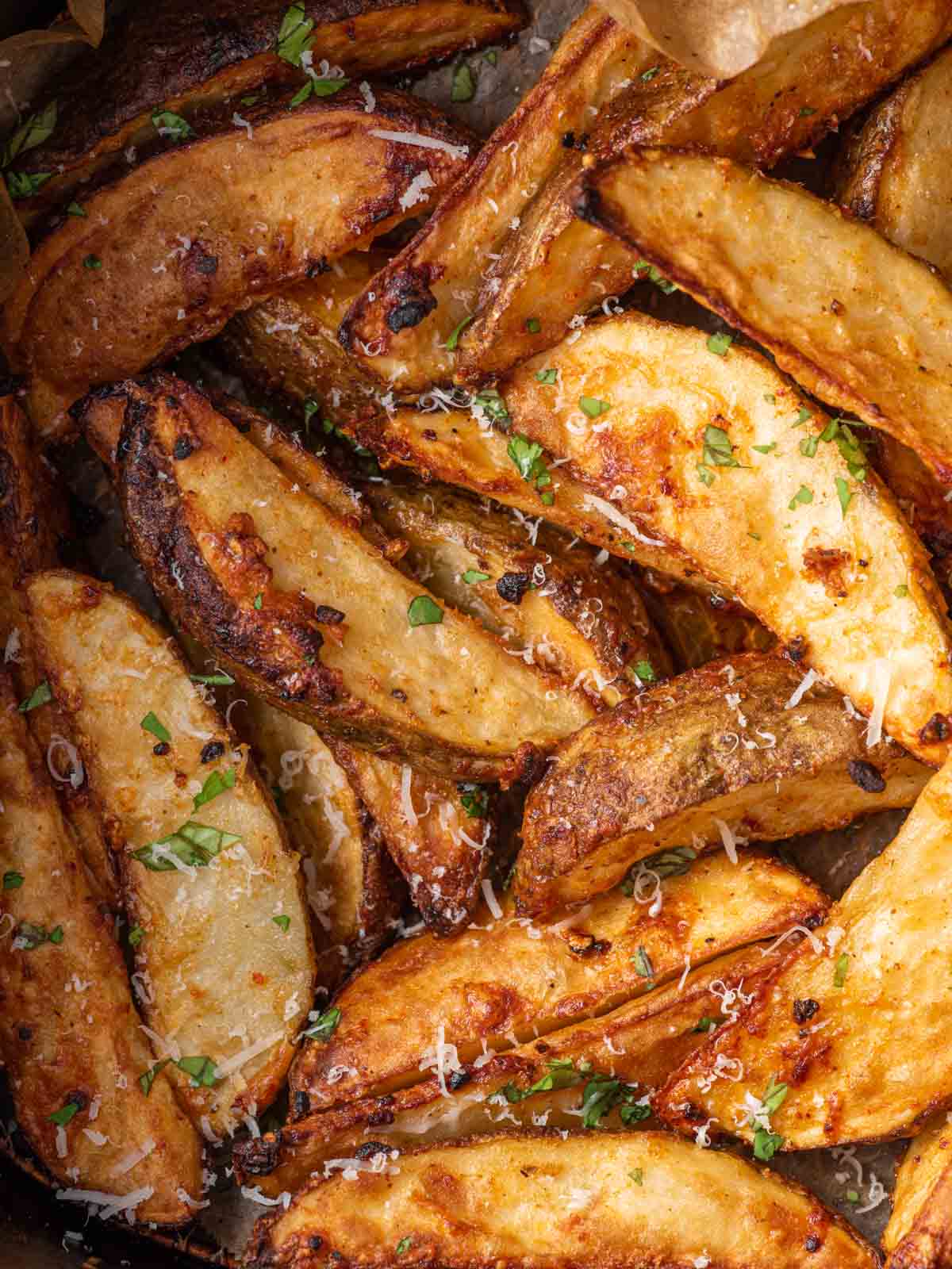 A pile of crispy parmesan potato wedges.