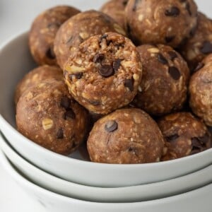 protein bites in a bowl with a bite taken out of one.