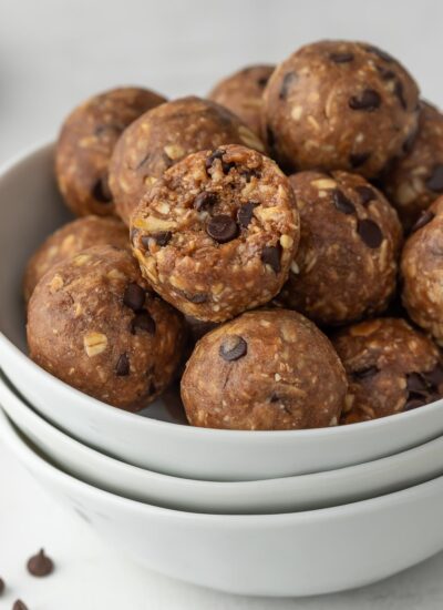 protein bites in a bowl with a bite taken out of one.