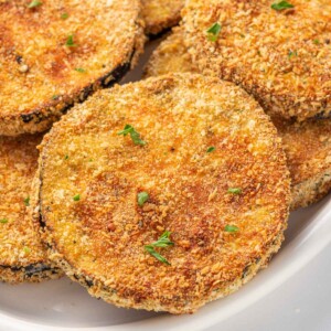 Close up of breaded crispy eggplant on a plate.