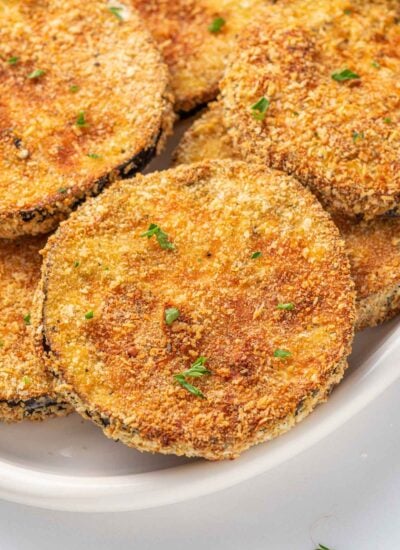 Close up of breaded crispy eggplant on a plate.